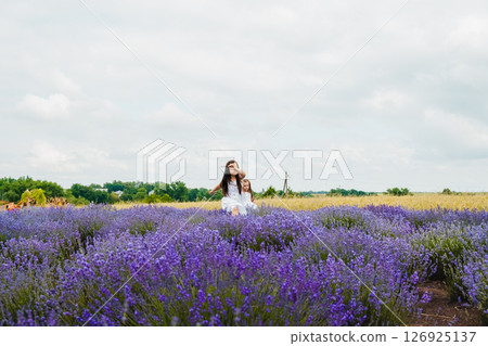 A black-haired girl is resting in a fragrant lavender field A black-haired girl is resting in a fragrant lavender field 126925137