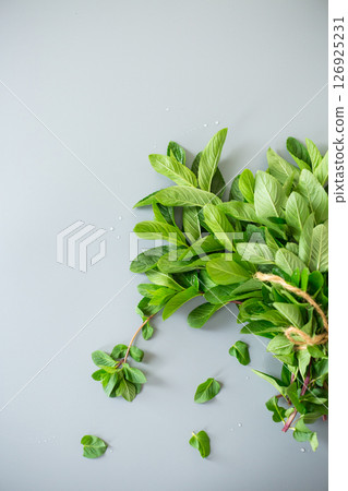 Green mint leaves close-up on stone background 126925231