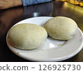 Close-Up of Two Traditional Izmir Bomba Pastries on a White Plate 126925730