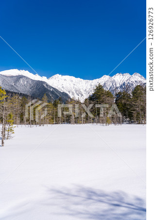 View of Mount Okuhotaka and Tsurione Ridge from the snow-covered Tashiro Marshland. Winter trekking in Kamikochi, Matsumoto City, Nagano Prefecture. View of Mount Okuhotaka and Tsurione Ridge from the snow-covered Tashiro Marshland. Winter trekking in Kamikochi, Matsumoto City, Nagano Prefecture. 126926773