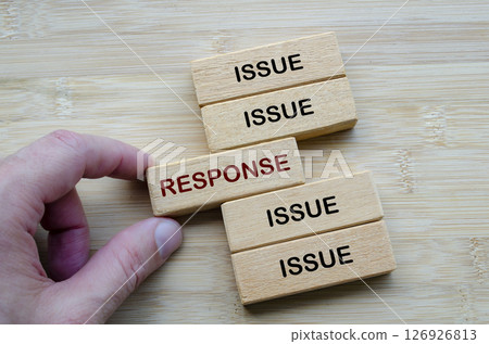 Issue and Response Dynamics highlighting how challenges are met with strategic responses, depicted on stacked wooden blocks Issue and Response Dynamics highlighting how challenges are met with strategic responses, depicted on stacked wooden blocks 126926813