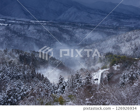 Snowy scenery of Mt. Ena seen from the observation deck of Magome-juku, a tourist spot on the Nakasendo road in winter Snowy scenery of Mt. Ena seen from the observation deck of Magome-juku, a tourist spot on the Nakasendo road in winter 126926934