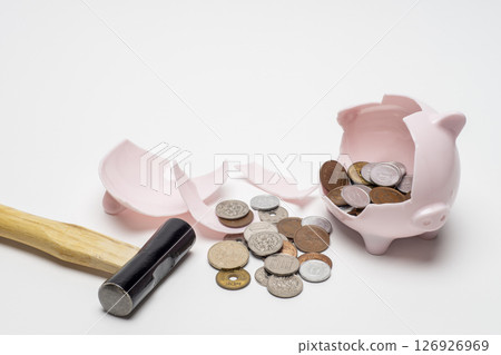Hammered piggy bank and coins Hammered piggy bank and coins 126926969