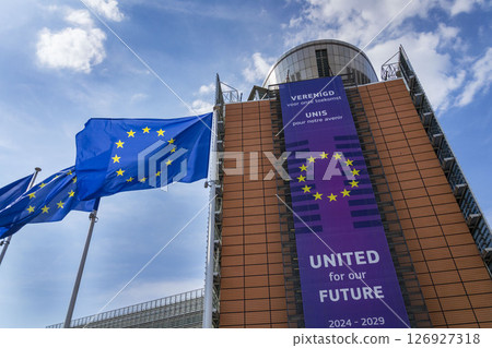 Waving EU flags in front of the Berlaymont building headquarters of the European Commission on May 20, 2025 in Brrussels, Belgium. 126927318