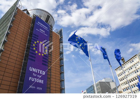 Waving EU flags in front of the Berlaymont building headquarters of the European Commission on May 20, 2025 in Brrussels, Belgium. 126927319