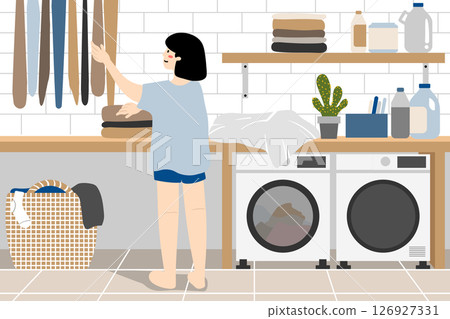 Woman hanging clothes in the laundry room. Woman hanging clothes in the laundry room. 126927331