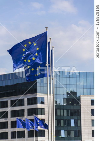 Waving EU flags in front of the Berlaymont building headquarters of the European Commission in Brussels, Belgium 126928169