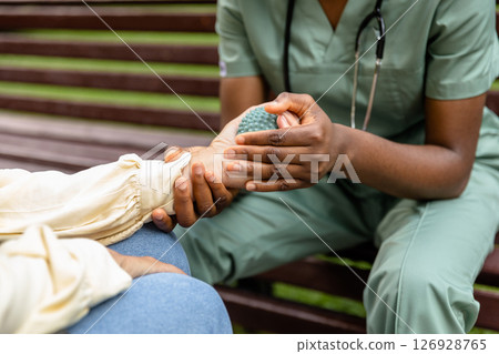 Close up picture of a nurse massaging patients hand with a massage ball 126928765