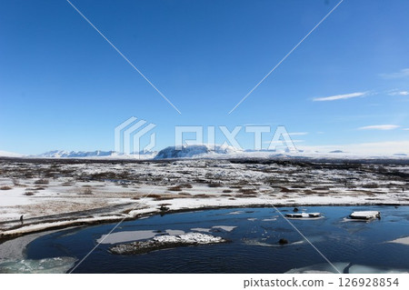 Thingvellir National Park on a blue sky day with the lake covered with ice and snow taken in March 126928854