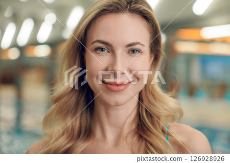 Pretty long-haired blonde young woman in the swimming pool 126928926