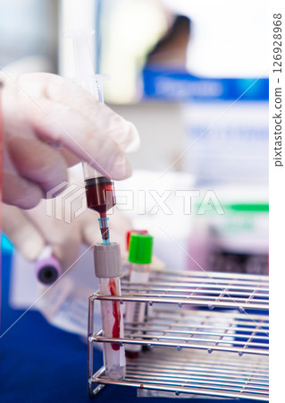 Close up blood sample for diagnosis and treatment patient in the hospital.Laboratory technician taking blood for blood chemistry analysis. Close up blood sample for diagnosis and treatment patient in the hospital.Laboratory technician taking blood for blood chemistry analysis. 126928968