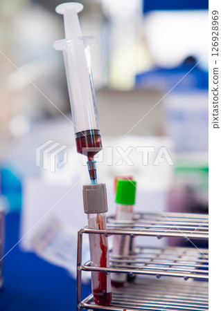 Close up blood sample for diagnosis and treatment patient in the hospital.Laboratory technician taking blood for blood chemistry analysis. Close up blood sample for diagnosis and treatment patient in the hospital.Laboratory technician taking blood for blood chemistry analysis. 126928969