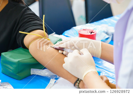 Close up hand collecting blood sample for diagnosis and treatment patient in the hospital.Laboratory technician taking blood for blood chemistry analysis 126928972