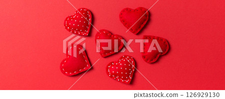 Composition of textile red hearts on colorful background. Close up view. Top view of St. Valentine's day concept Composition of textile red hearts on colorful background. Close up view. Top view of St. Valentine's day concept 126929130