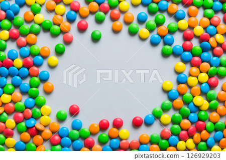 Mixed collection of colorful candy, on colored background. Flat lay, top view. frame of colorful chocolate coated candy 126929203