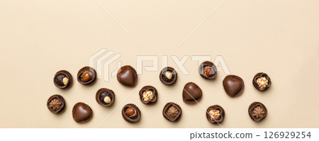 Different kinds of chocolates on colored table close-up. Top View and Flat Lay with copy space Different kinds of chocolates on colored table close-up. Top View and Flat Lay with copy space 126929254