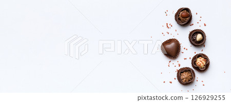 Different kinds of chocolates on colored table close-up. Top View and Flat Lay with copy space Different kinds of chocolates on colored table close-up. Top View and Flat Lay with copy space 126929255