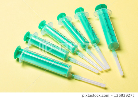 Top view of medical syringes on colorful background. Health care concept with copy space Top view of medical syringes on colorful background. Health care concept with copy space 126929275