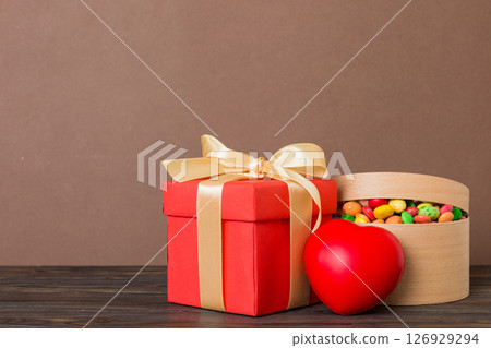Valentine day composition: sweet candy, with gift boxes with bow and red felt hearts, photo template, background. Perspective View with copy space Valentine day composition: sweet candy, with gift boxes with bow and red felt hearts, photo template, background. Perspective View with copy space 126929294