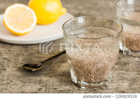 Healthy breakfast or morning with chia seeds and lemon on table background, vegetarian food, diet and health concept. Chia pudding with lemon Healthy breakfast or morning with chia seeds and lemon on table background, vegetarian food, diet and health concept. Chia pudding with lemon 126929319