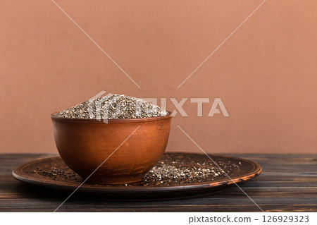Chia seeds in bowl on colored background. Healthy Salvia hispanica in small bowl. Healthy superfood 126929323