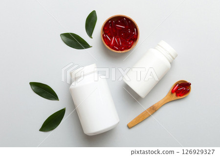 different drugs and health supplement pills with medicine bottle health care and medical top view. Vitamin tablets. Bottle with colored pills on table background. Multivitamins 126929327