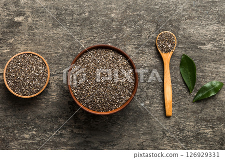 Chia seeds in bowl and spoon on colored background. Healthy Salvia hispanica in small bowl. Healthy superfood 126929331