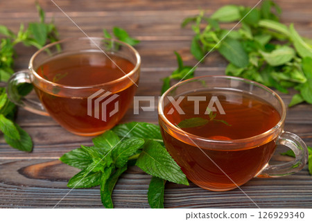 Cup of mint tea on table background. Green tea with fresh mint top view with copy space 126929340