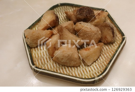 close up of deep fried Taiwanese snacks king trumpet mushroom cut into pieces on a plate close up of deep fried Taiwanese snacks king trumpet mushroom cut into pieces on a plate 126929363