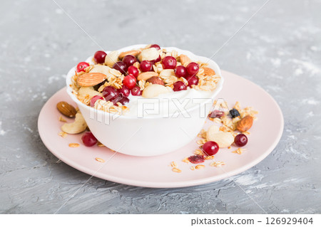 Healthy breakfast food with granola, yogurt, fruits and nuts. Dessert parfait with dried fruits for breakfast 126929404