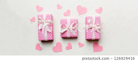 Valentine day composition Background: red gift box with bow and heart. Christmas present. View from above. Holday greeting card 126929416