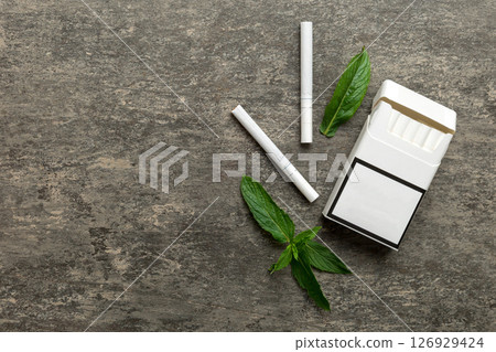 Pack of menthol cigarettes and fresh mint on colored table, Menthol cigarettes top view flat lay 126929424