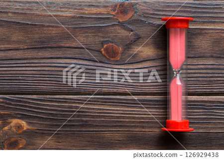 hourglass on the table, sand clock as time passing concept for business deadline, copy space 126929438