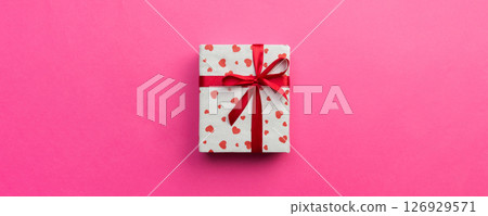 Background with gift box and hearts on pink Background. Top view with copy space for text Background with gift box and hearts on pink Background. Top view with copy space for text 126929571
