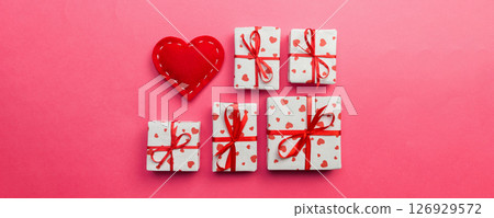 Gift box with red hearts on coral background. top view with copy space Gift box with red hearts on coral background. top view with copy space 126929572