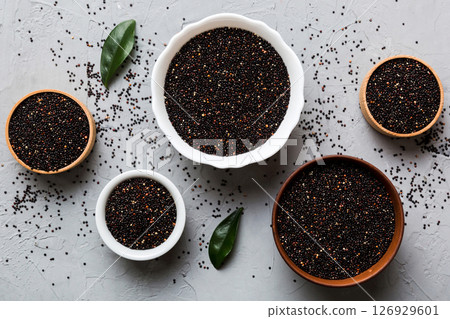 quinoa seeds in bowl on colored background. Healthy kinwa in small bowl. Healthy superfood quinoa seeds in bowl on colored background. Healthy kinwa in small bowl. Healthy superfood 126929601