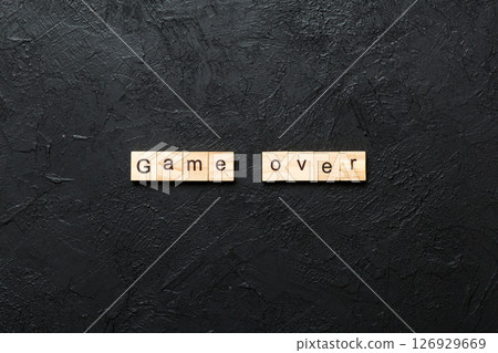 game over word written on wood block. game over text on table, concept game over word written on wood block. game over text on table, concept 126929669