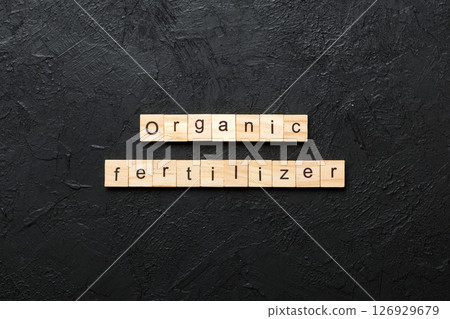organic fertilizer word written on wood block. organic fertilizer text on cement table for your desing, concept 126929679