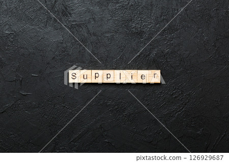 SUPPLIER word written on wood block. SUPPLIER text on cement table for your desing, concept SUPPLIER word written on wood block. SUPPLIER text on cement table for your desing, concept 126929687