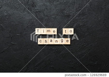 TIME TO CHANGE word written on wood block. TIME TO CHANGE text on table, concept 126929689