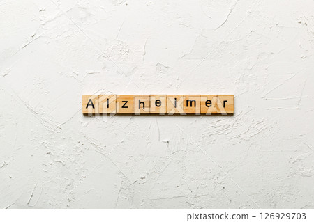 Alzheimer word written on wood block. Alzheimer text on cement table for your desing, concept Alzheimer word written on wood block. Alzheimer text on cement table for your desing, concept 126929703