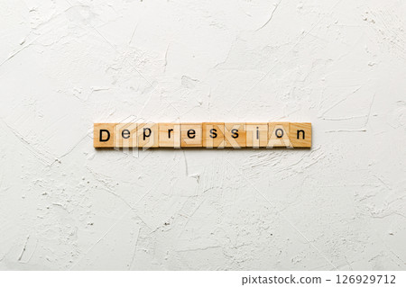 Depression word written on wood block. Depression text on table, concept 126929712