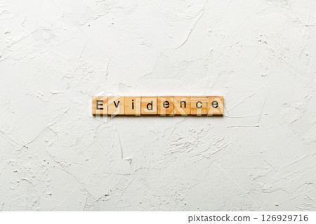 evidence word written on wood block. evidence text on table, concept 126929716