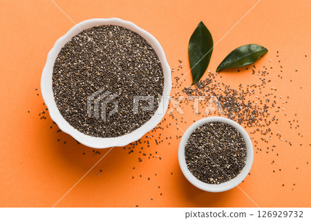 Chia seeds in bowl on colored background. Healthy Salvia hispanica in small bowl. Healthy superfood Chia seeds in bowl on colored background. Healthy Salvia hispanica in small bowl. Healthy superfood 126929732