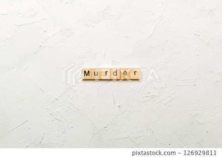 murder word written on wood block. murder text on table, concept murder word written on wood block. murder text on table, concept 126929811