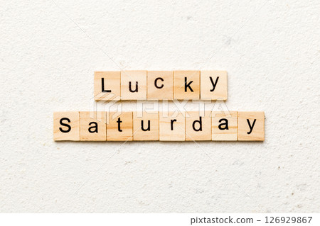 lucky saturday word written on wood block. lucky saturday text on cement table for your desing, concept lucky saturday word written on wood block. lucky saturday text on cement table for your desing, concept 126929867