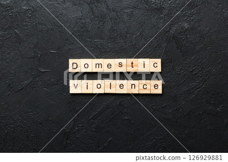 Domestic violence word written on wood block. Domestic violence text on cement table for your desing, Top view concept 126929881