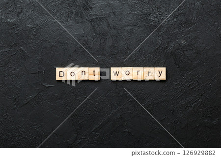 Don't worry word written on wood block. Don't worry text on cement table for your desing, Top view concept 126929882