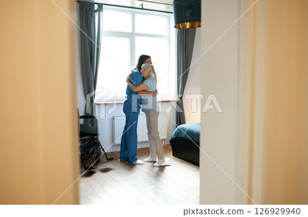 Elderly patient hugging her nurse after a nice exercising 126929940