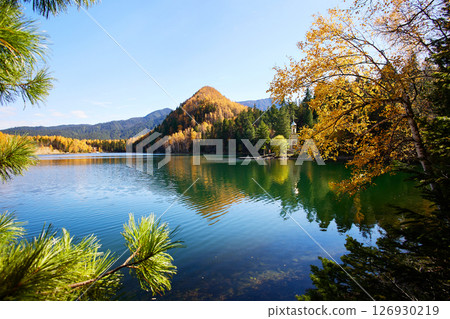 Beautiful autumn landscape. Orthodox chapel on the shore of the Emerald Lake. Beautiful autumn landscape. Orthodox chapel on the shore of the Emerald Lake. 126930219